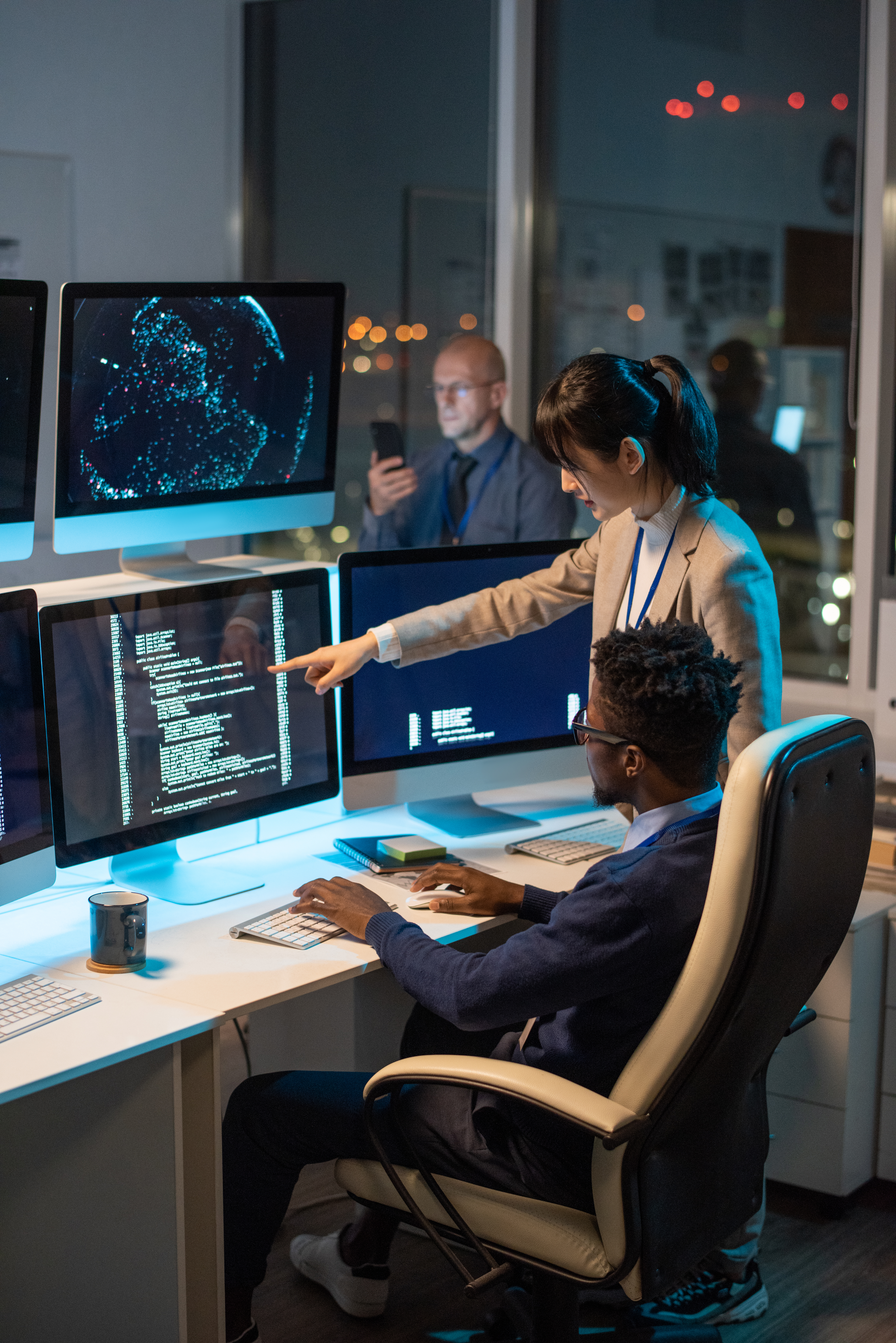 Developers collaborating on AI project in an urban office